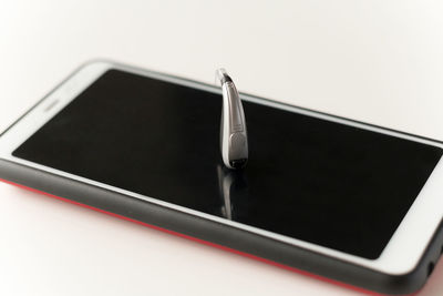 High angle view of smart phone against white background