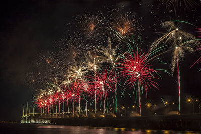 Low angle view of firework display at night