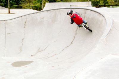 Boy on bicycle at skateboard park