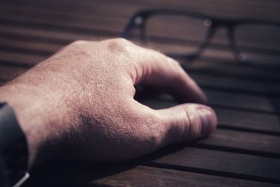 Close-up of hand on table