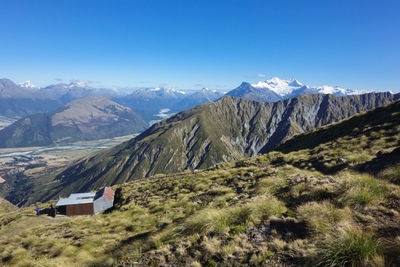 Scenic view of snowcapped mountains against blue sky