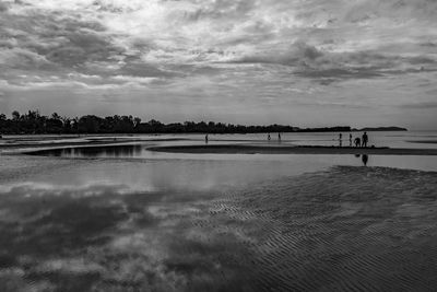 View of beach against cloudy sky