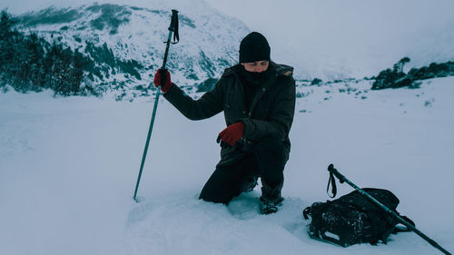 Full length of man holding ice on mountain