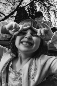 Close-up of playful girl in pick-up truck at park