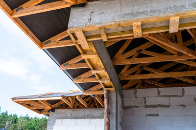 Roof trusses covered with a membrane on a detached house under construction, visible roof elements