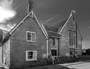 Exterior of old building by street against sky