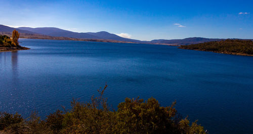 Scenic view of lake against blue sky