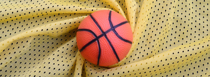 Directly above shot of basketball on patterned fabric