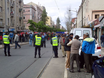 Rear view of people walking on city street