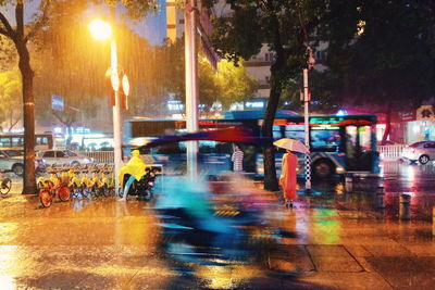 Blurred motion of people on city street at night