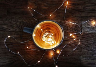 High angle view of coffee with lighting equipment on table