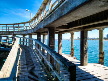 Bridge over sea against blue sky