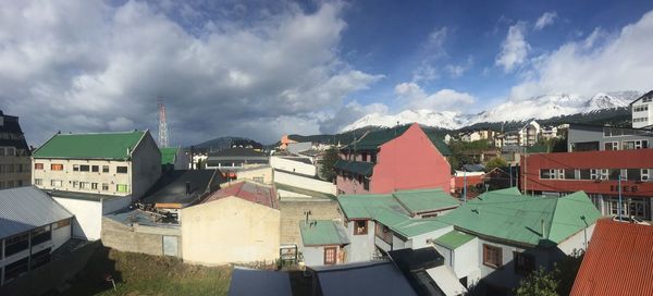 Panoramic view of buildings in town against sky