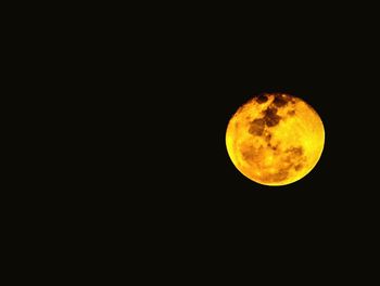 Low angle view of moon against black sky