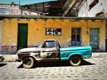 Old vintage car against building in city