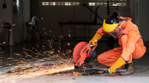 Man working on metal structure in factory