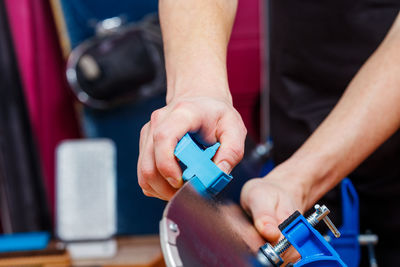 Midsection of man repairing car