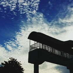 Low angle view of silhouette built structure against sky