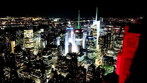 Aerial view of city lit up at night