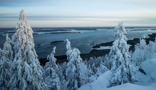 Scenic view of snow covered sea against sky