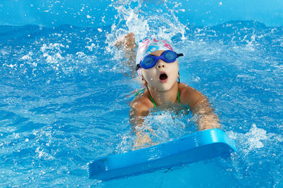 Portrait of woman swimming in pool