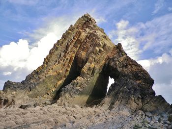 Low angle view of rock formation against sky