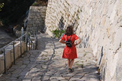 Rear view of woman walking on staircase