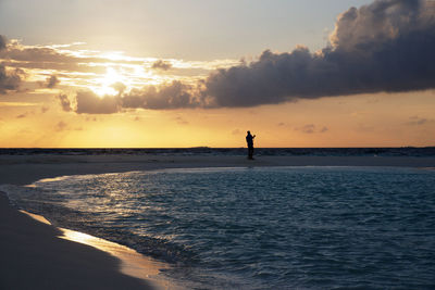 Man on beach at sunset