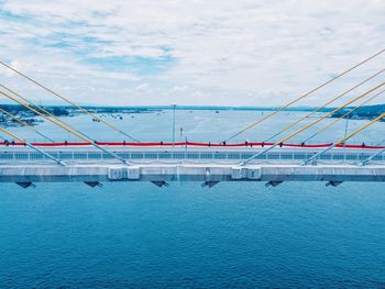 View of swimming pool by sea against sky