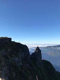 Scenic view of mountains against clear blue sky