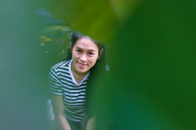 Portrait of smiling young woman standing outdoors