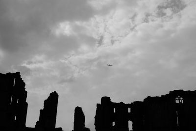 Low angle view of built structure against cloudy sky