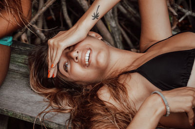 High angle view of young woman lying on field