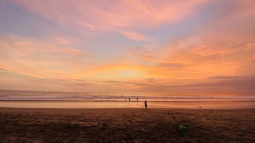 Scenic view of beach against sky during sunset