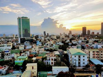 Buildings in city against sky during sunset