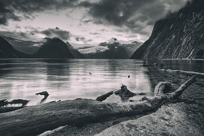 Calm lake against mountain range