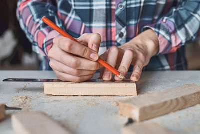 Midsection of carpenter working at workshop