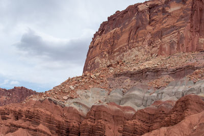 Capitol reef national park low angle landscape of pink, orange and purple barren stone hillside 