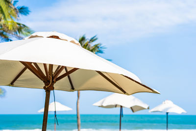 Umbrella on beach against sky