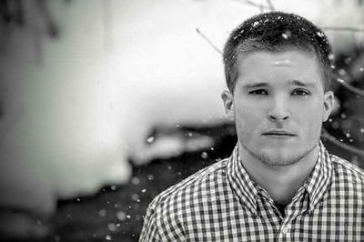 Portrait of young man during snowfall