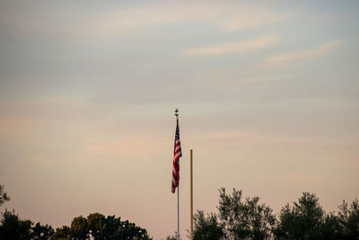 Low angle view of flag against sky during sunset