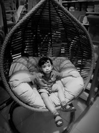 Portrait of young woman sitting at home