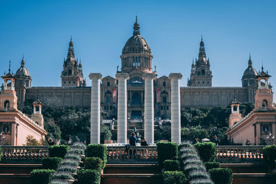 View of buildings in city against clear sky