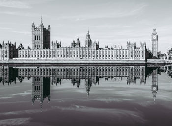 Reflection of building on water in city