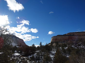 Low angle view of mountain against blue sky