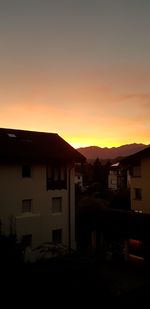 Silhouette buildings against sky during sunset