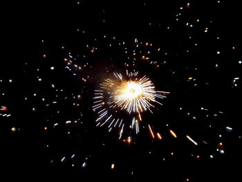 Low angle view of firework display at night