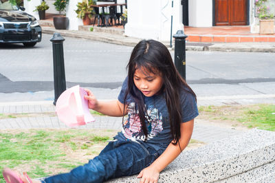 Girl sitting in city