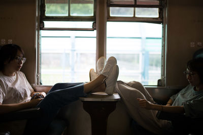 Young women relaxing while traveling in train