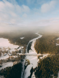 Scenic view of river against sky during winter